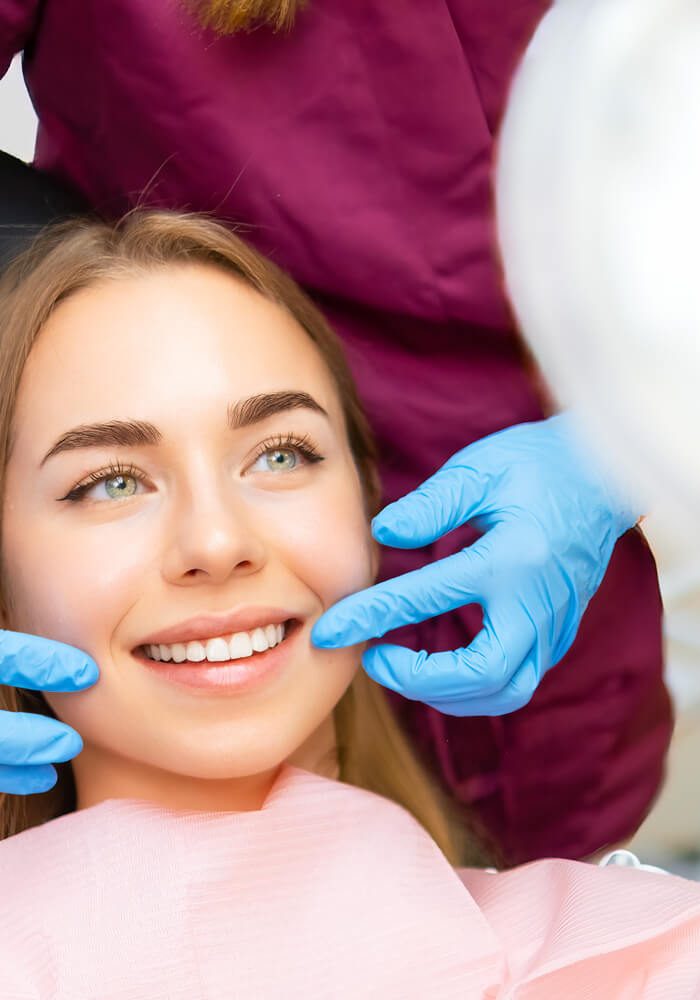Patientin zeigt Zahnarzt Ihr Lächeln